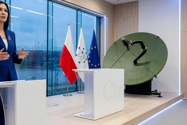 Prezentacja bezpiecznej łączności satelitarnej - antena i flagi Polski oraz Unii Europejskiej